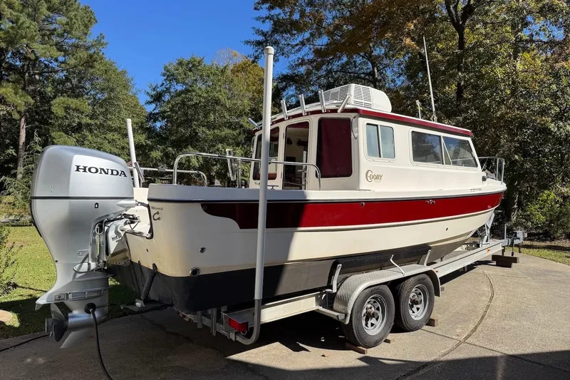 Slide: The Image of 2007 C-Dory 25 Pilothouse boat on trailer with Honda outboard motor. - 6