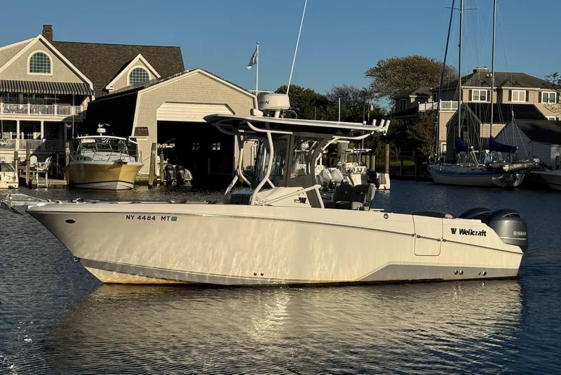 The Image of 2023 Wellcraft 262 Fisherman boat docked near waterfront homes. - 0