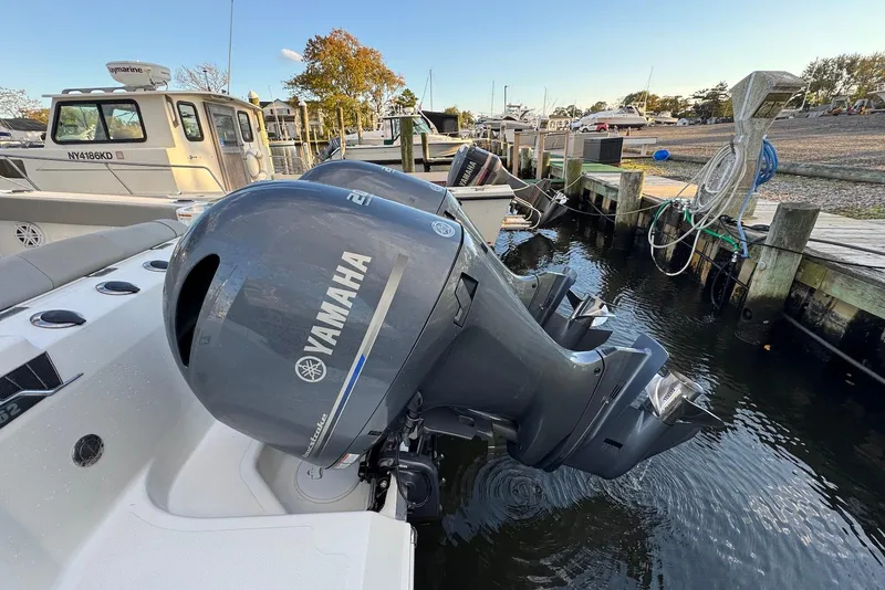 Slide: The Image of 2023 Wellcraft 262 Fisherman with Yamaha outboard engine docked at marina. - 17