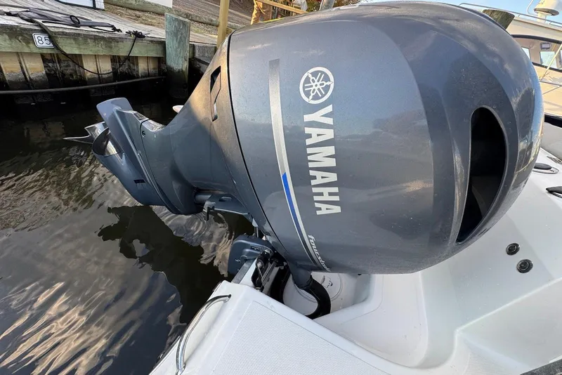 Slide: The Image of Yamaha outboard motor on 2023 Wellcraft 262 Fisherman boat, docked by wooden pier. - 18
