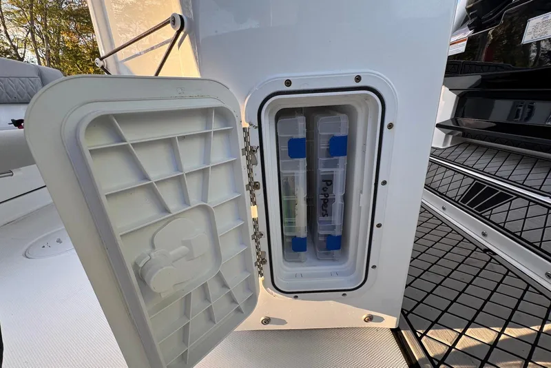 Slide: The Image of 2023 Wellcraft 262 Fisherman storage compartment with tackle boxes inside. - 20