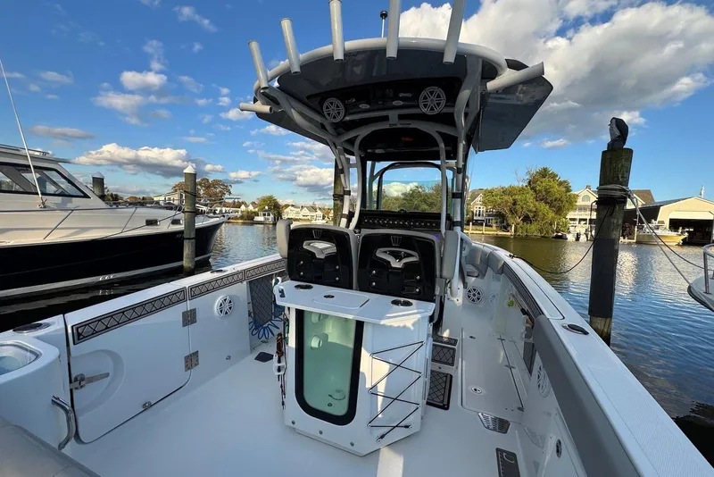 Slide: The Image of 2023 Wellcraft 262 Fisherman boat docked, featuring spacious deck and modern amenities. - 3