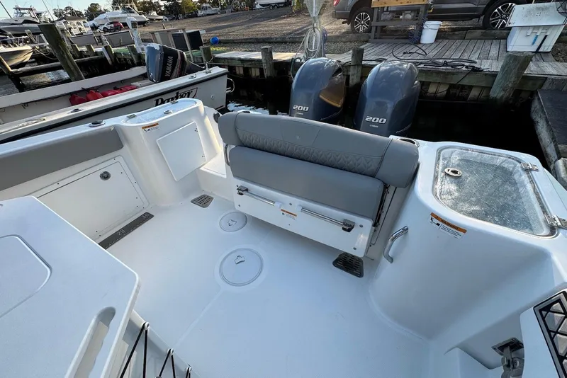 Slide: The Image of 2023 Wellcraft 262 Fisherman boat interior with dual engines at dock. - 5
