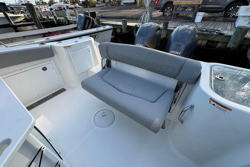 Slide: The Image of 2023 Wellcraft 262 Fisherman boat interior with seating and dual engines. - 6
