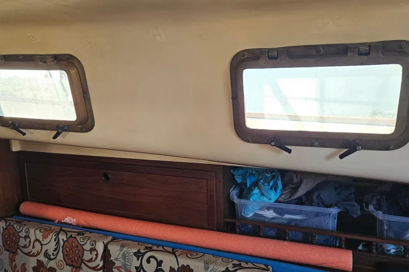 Slide: The Image of Interior view of a 1988 Bayfield 32C sailboat cabin with wooden finishes. - 15