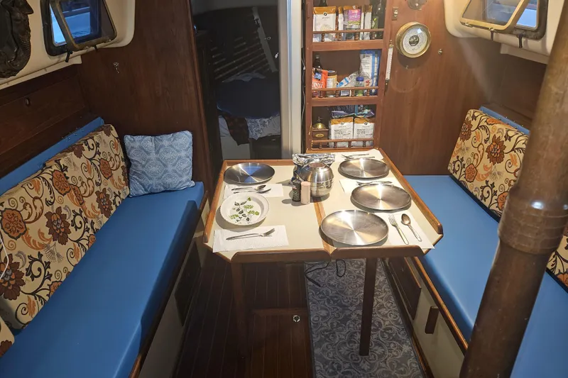 Slide: The Image of Interior of 1988 Bayfield 32C sailboat with portholes and storage area. - 16