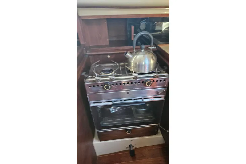 Slide: The Image of Interior of a 1988 Bayfield 32C sailboat with dining setup and cozy seating. - 17