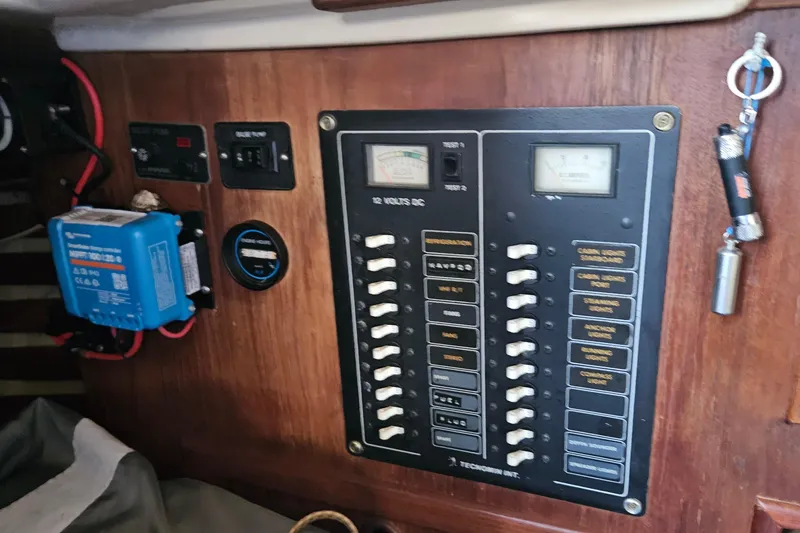 Slide: The Image of Interior view of a 1988 Bayfield 32C sailboat, showing a porthole and lamp. - 19
