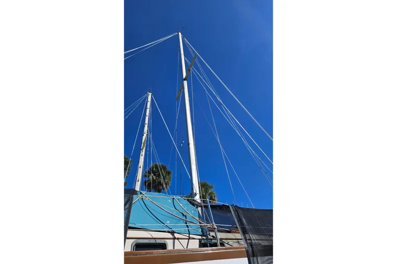 Slide: The Image of 1988 Bayfield 32C boat bathroom with sink, wooden cabinetry, and compact toilet. - 22