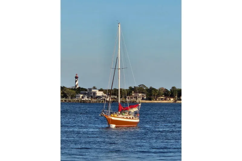 Slide: The Image of Red hull of 1988 Bayfield 32C sailboat with orange straps and metal support. - 24