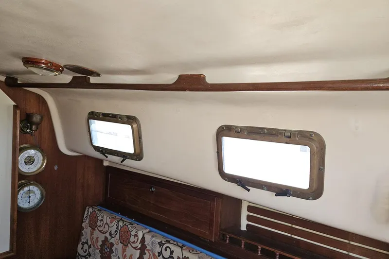 Slide: The Image of Interior of 1988 Bayfield 32C sailboat with portholes and wooden accents. - 26