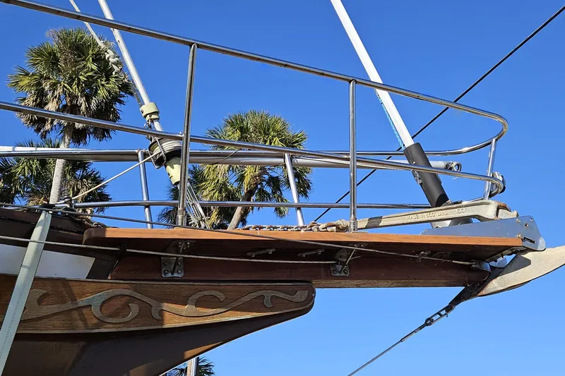 Slide: The Image of Bow of 1988 Bayfield 32C sailboat with palm trees and clear blue sky. - 29