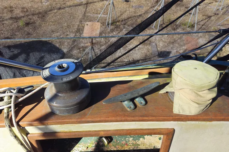 Slide: The Image of 1988 Bayfield 32C sailboat deck with winch, cleat, and canvas cover. - 30