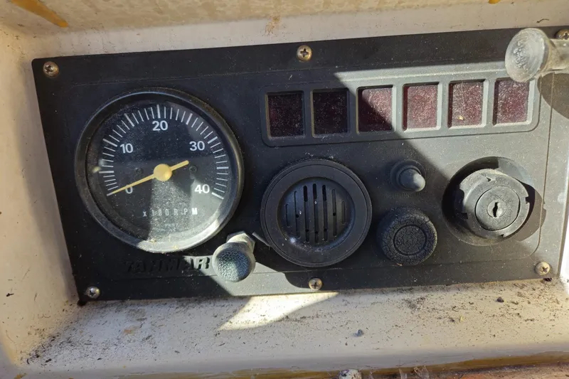 Slide: The Image of Control panel of a 1988 Bayfield 32C boat with RPM gauge and switches. - 32
