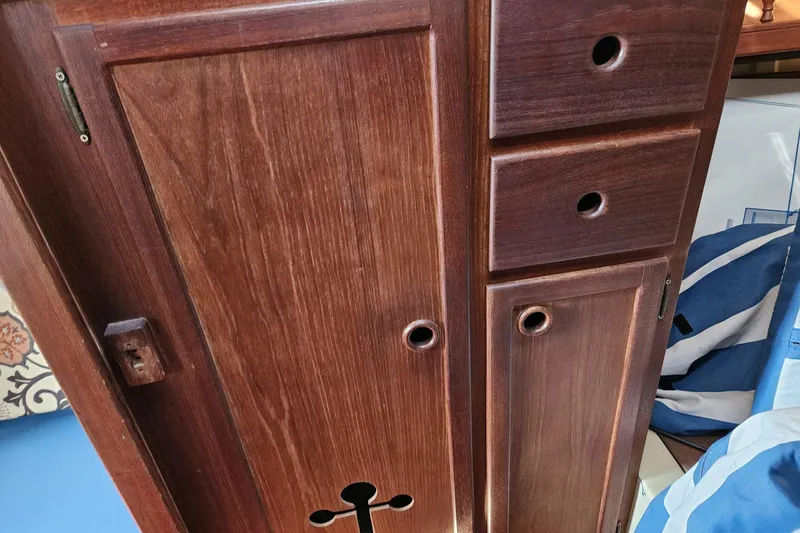 Slide: The Image of Wooden cabinetry inside a 1988 Bayfield 32C boat, featuring drawers and a cross-shaped cutout. - 36
