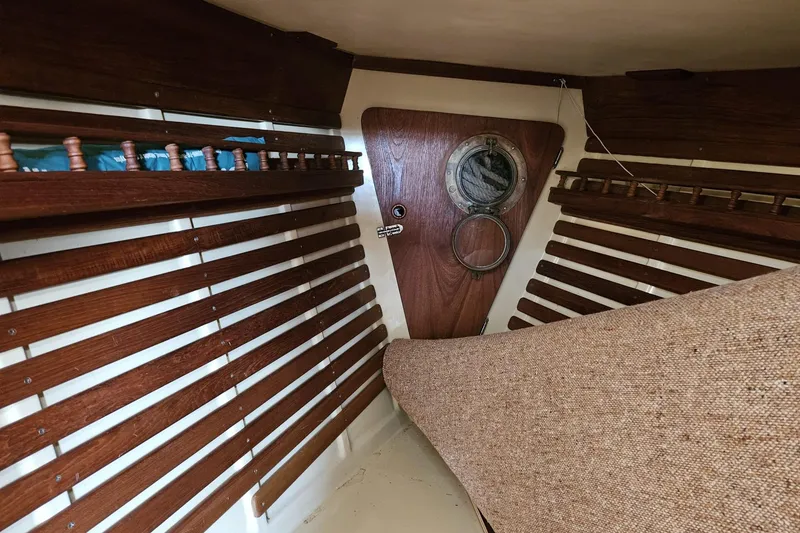 Slide: The Image of Interior of a 1988 Bayfield 32C sailboat with wooden paneling and porthole. - 37