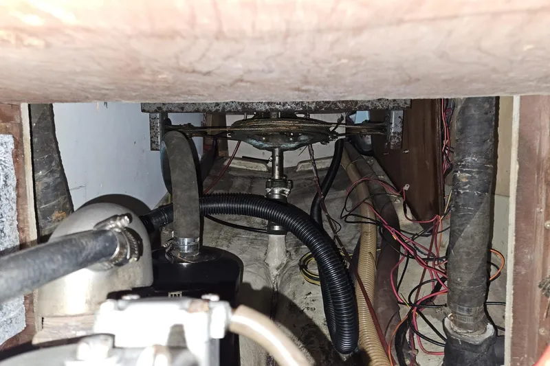 Slide: The Image of 1988 Bayfield 32C boat engine compartment with hoses and wiring visible. - 43