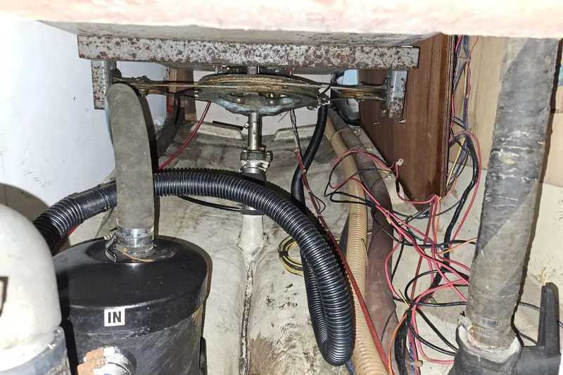 Slide: The Image of Engine compartment of a 1988 Bayfield 32C sailboat with hoses and wiring visible. - 44