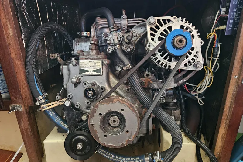Slide: The Image of Engine of a 1988 Bayfield 32C sailboat, featuring belts and hoses. - 45