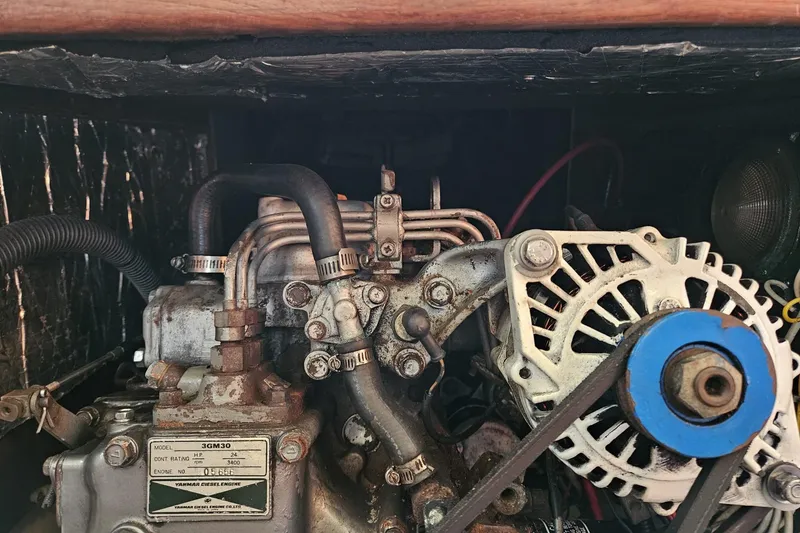 Slide: The Image of Engine compartment of a 1988 Bayfield 32C sailboat, featuring a Yanmar diesel engine. - 47