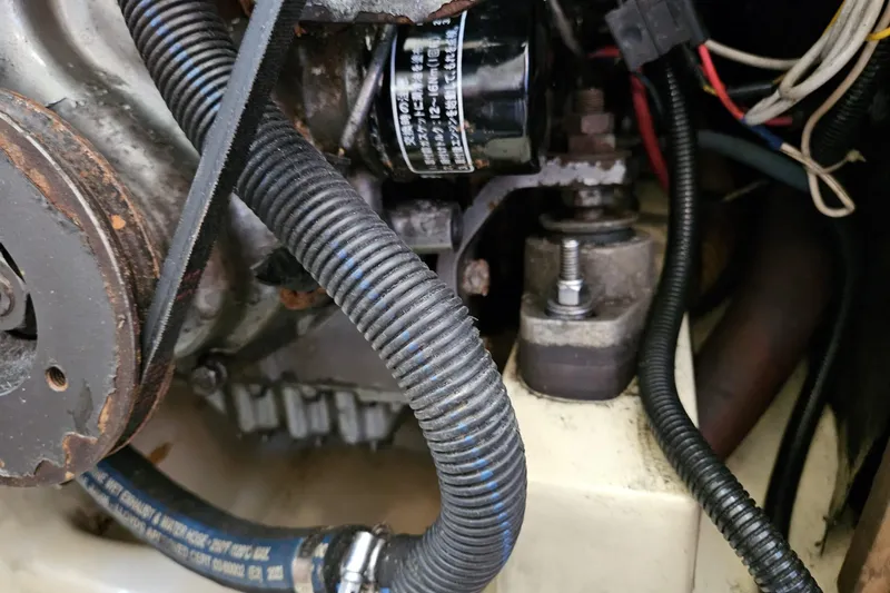 Slide: The Image of Close-up of a 1988 Bayfield 32C engine compartment with visible hoses and components. - 48