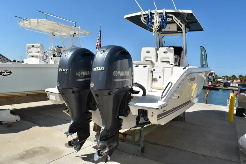 Slide: The Image of 2022 Pursuit S 268 Sport boat with dual Yamaha 200 engines docked at marina. - 0