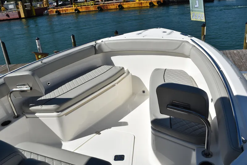 Slide: The Image of 2022 Pursuit S 268 Sport boat console with cup holders and storage compartment. - 10