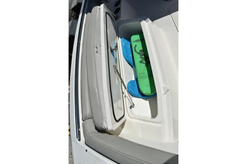 Slide: The Image of 2022 Pursuit S 268 Sport boat dashboard with steering wheel, navigation screens, and controls. - 13