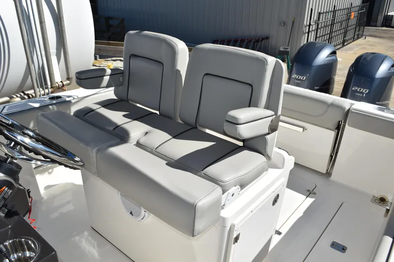 Slide: The Image of 2022 Pursuit S 268 Sport boat cockpit with steering wheel and control panel. - 24