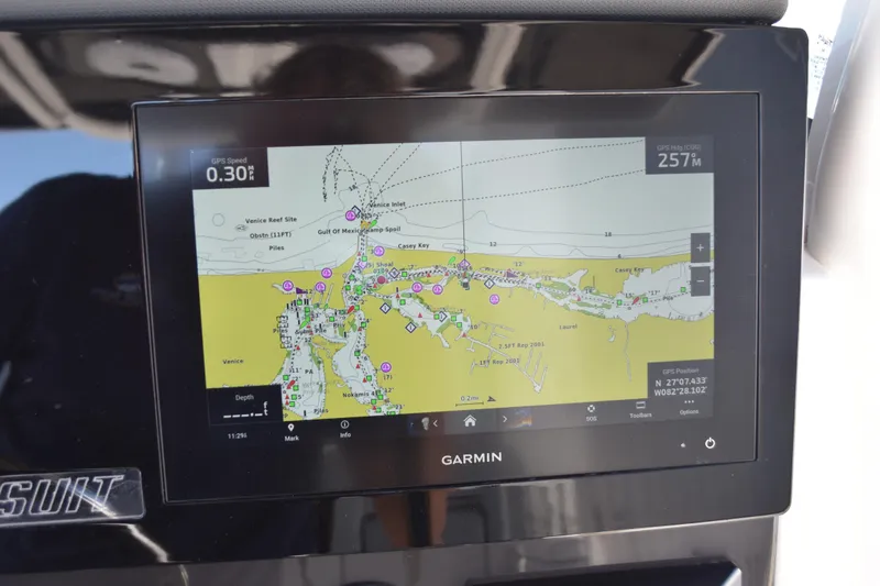 Slide: The Image of Open storage compartment on 2022 Pursuit S 268 Sport boat with orange life jackets. - 27