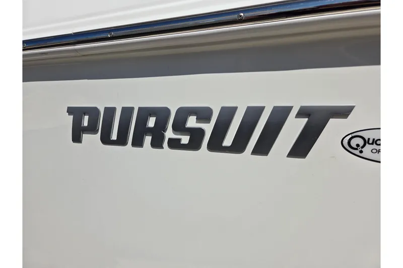 Slide: The Image of 2022 Pursuit S 268 Sport boat in storage, front view, near industrial building. - 3