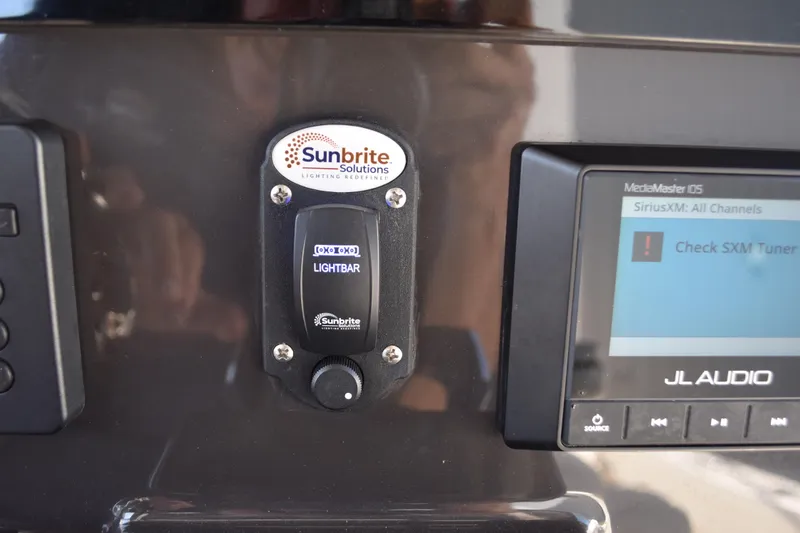 Slide: The Image of 2022 Pursuit S 268 Sport boat storage compartment with green and blue items inside. - 31