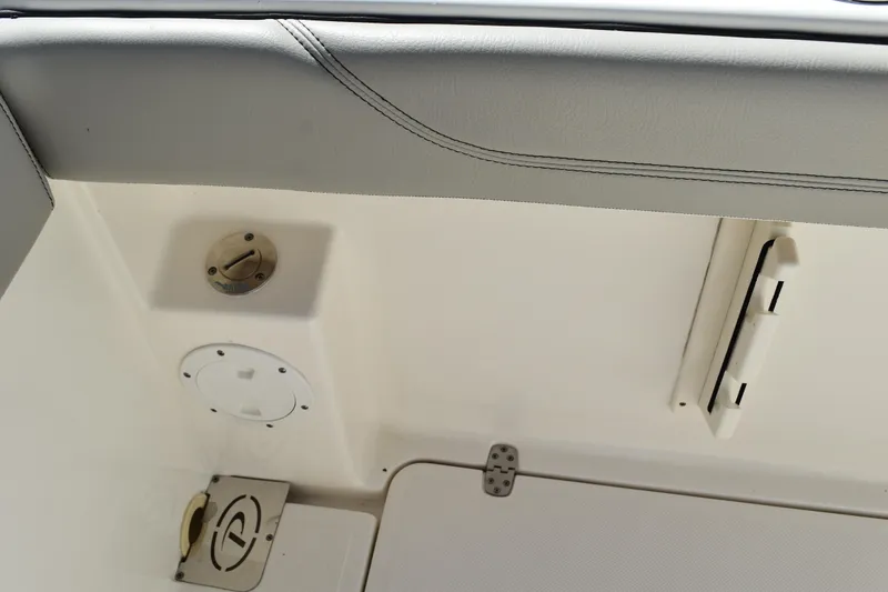 Slide: The Image of 2022 Pursuit S 268 Sport boat interior with compact marine toilet and storage. - 37