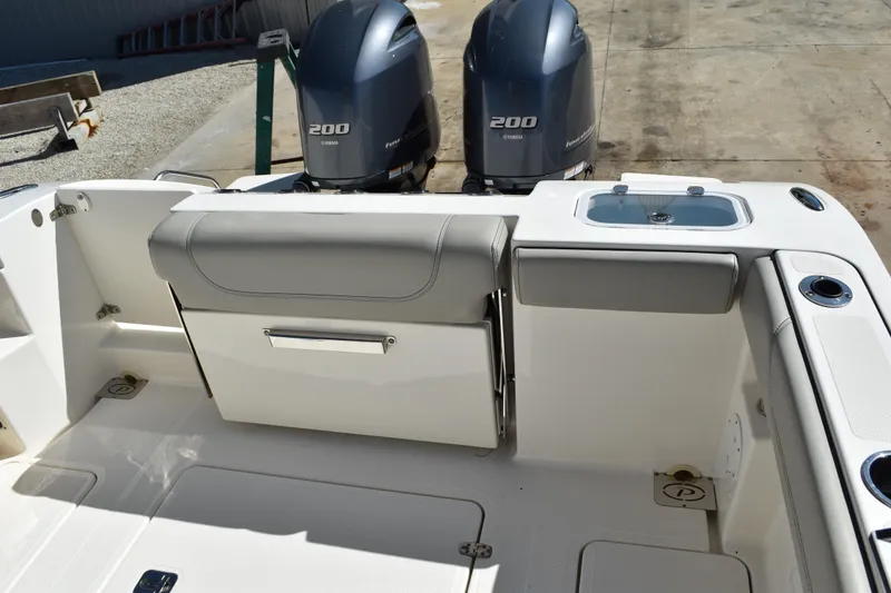 Slide: The Image of Control panel of a 2022 Pursuit S 268 Sport boat, featuring switches and dials. - 49