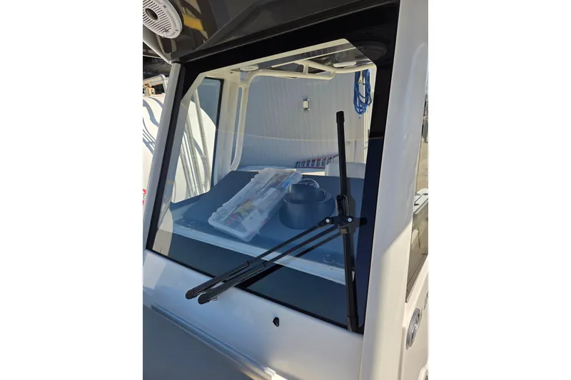 Slide: The Image of 2022 Pursuit S 268 Sport boat docked at a marina under clear blue skies. - 5