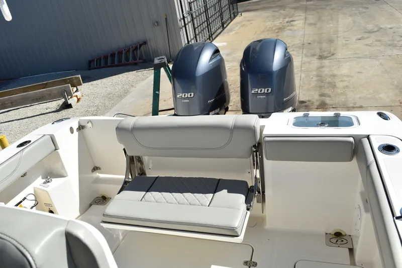 Slide: The Image of 2022 Pursuit S 268 Sport boat interior with mounted cleaning brush and equipment. - 50