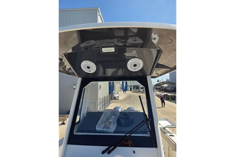 Slide: The Image of 2022 Pursuit S 268 Sport boat with dual Yamaha 200 engines docked by the water. - 6