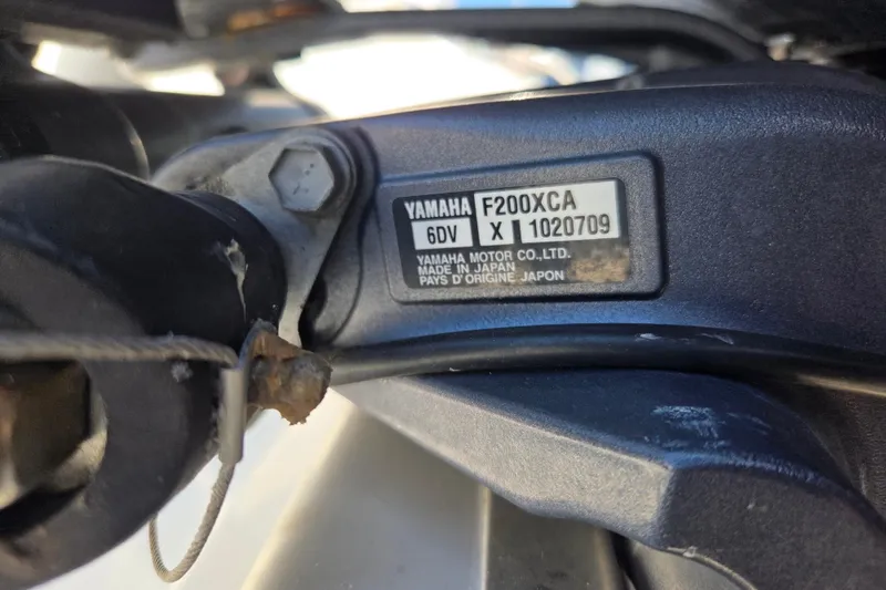 Slide: The Image of Open storage compartment on 2022 Pursuit S 268 Sport boat with fishing gear. - 8