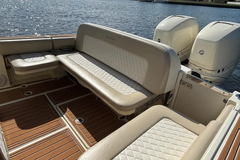 Slide: The Image of 2018 Chris-Craft Catalina 30 boat interior with beige seating and twin outboard engines. - 10