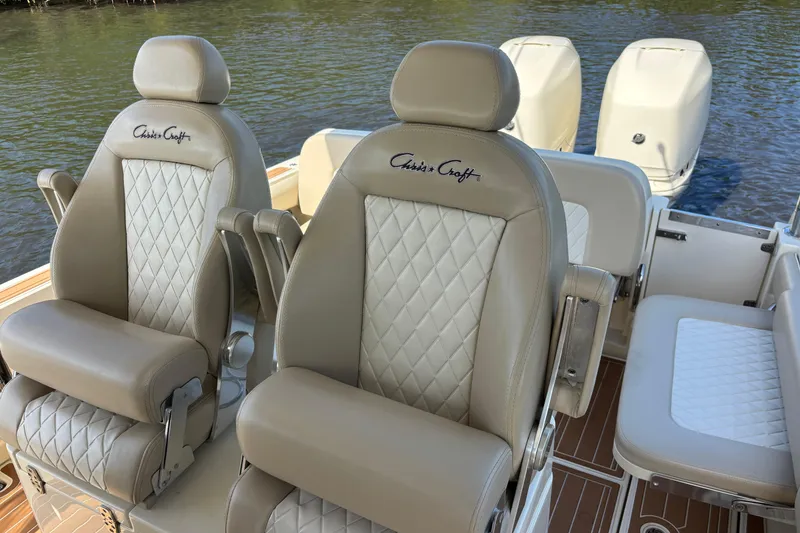 Slide: The Image of Luxurious seating on 2018 Chris-Craft Catalina 30 boat with dual engines in the background. - 12