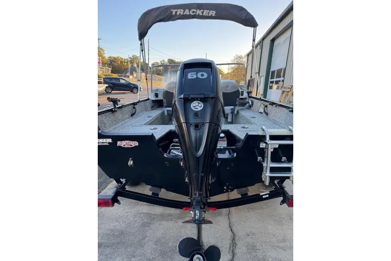 Slide: The Image of 2016 Tracker Pro Guide V-16 WT boat with 50 HP outboard motor, parked outdoors. - 3