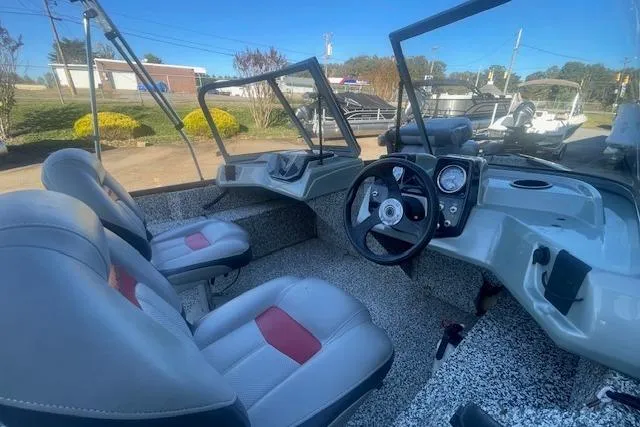 Slide: The Image of 2016 Tracker Pro Guide V-16 WT boat interior with steering wheel and seating. - 5