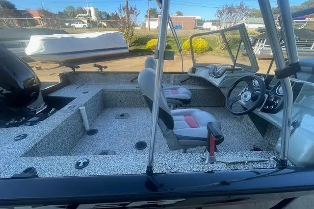 Slide: The Image of 2016 Tracker Pro Guide V-16 WT boat interior with seating and steering console. - 6