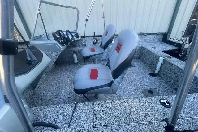 Slide: The Image of 2016 Tracker Pro Guide V-16 WT boat interior with dual seats and control panel. - 7