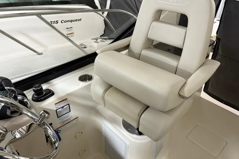 Slide: The Image of 2022 Boston Whaler 325 Conquest helm seat and controls, showcasing luxury and functionality. - 21