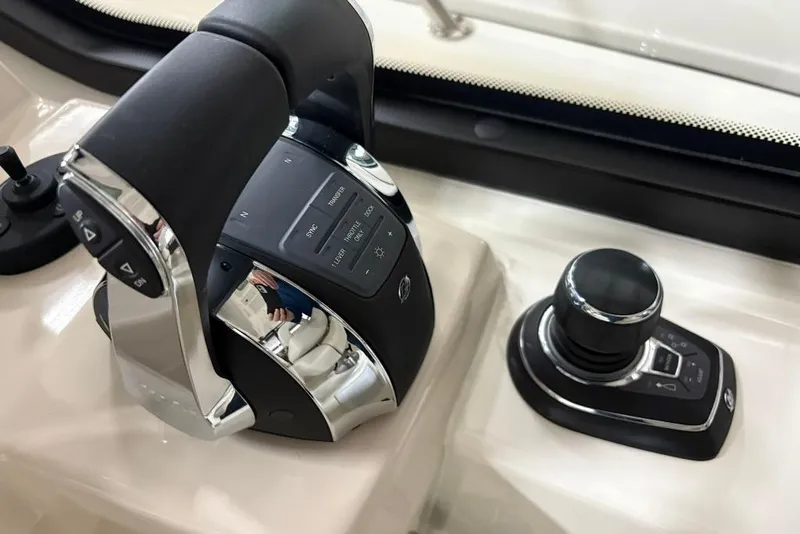 Slide: The Image of Control panel of 2022 Boston Whaler 325 Conquest boat, featuring modern throttle and joystick. - 22
