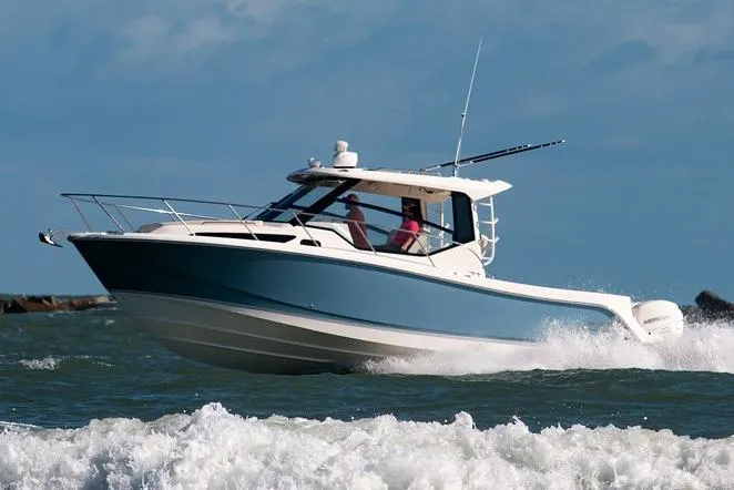 Slide: The Image of 2022 Boston Whaler 325 Conquest navigating through ocean waves. - 23