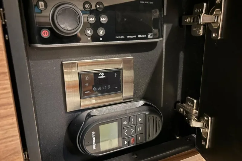 Slide: The Image of Control panel inside a 2022 Boston Whaler 325 Conquest boat, featuring Dometic and Raymarine devices. - 28