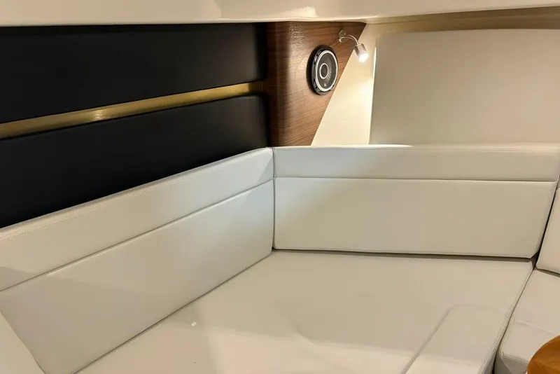 Slide: The Image of Interior of 2022 Boston Whaler 325 Conquest, featuring white cushioned seating and modern design elements. - 33