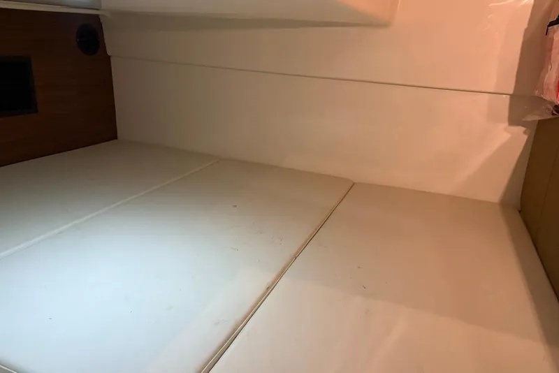 Slide: The Image of Interior cabin of 2022 Boston Whaler 325 Conquest with white cushioned seating. - 35